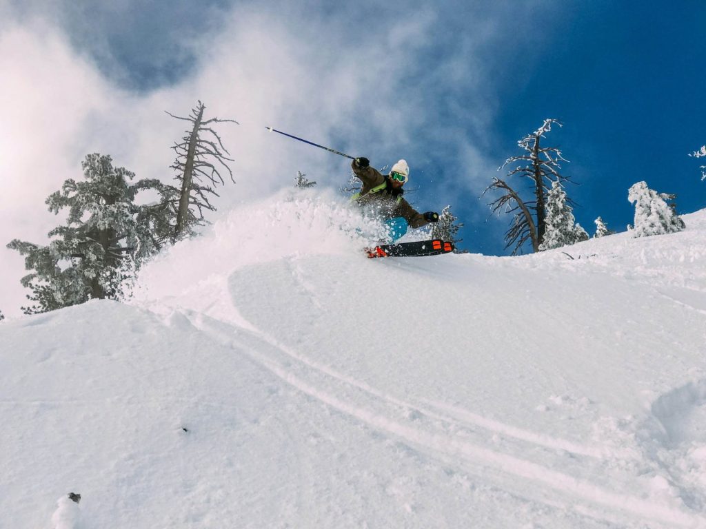 Snowboarder carving through snow